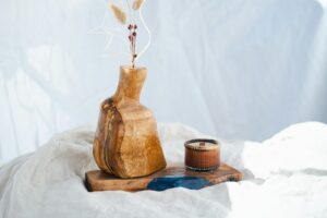 Vase with dried flowers and candle