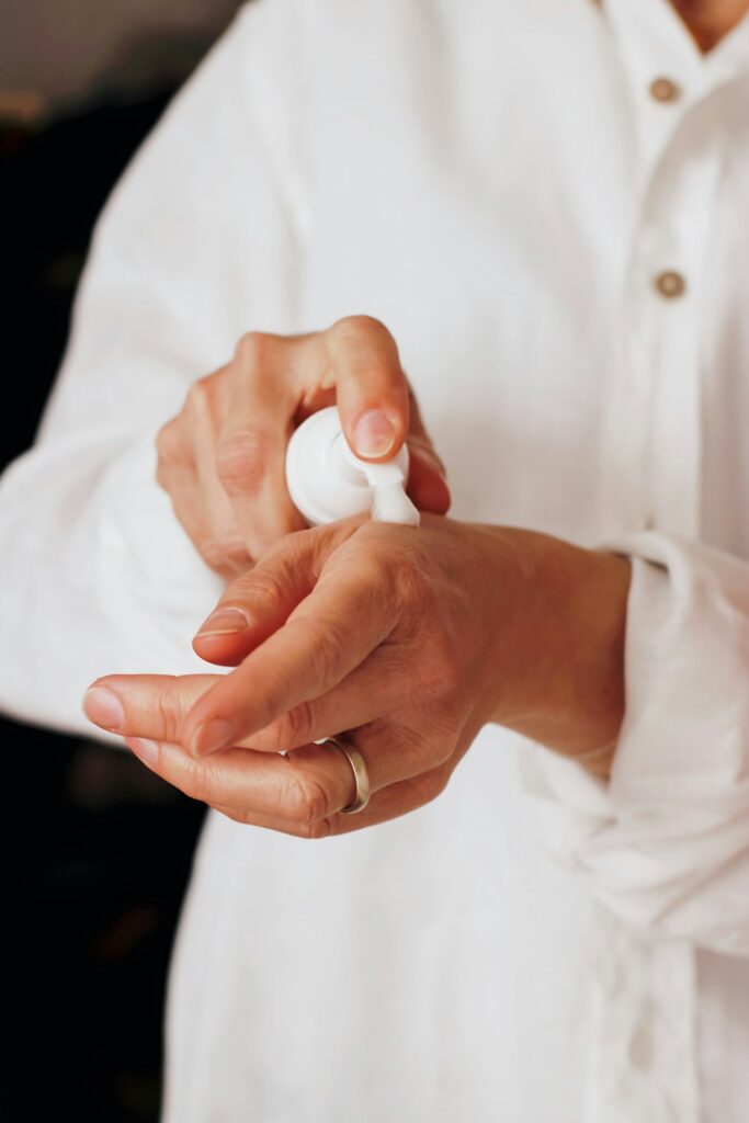 Hands applying lotion